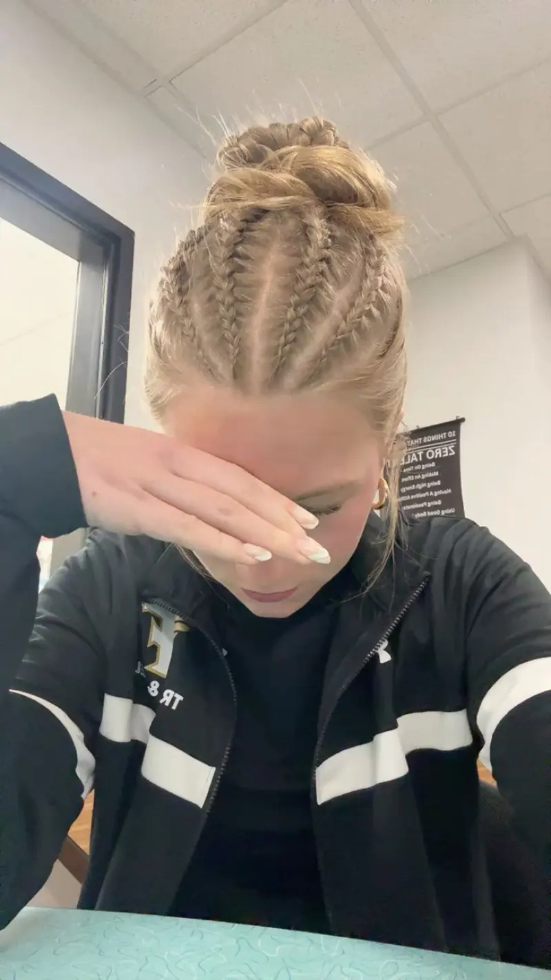 sleek braided hi bun softball hairstyle