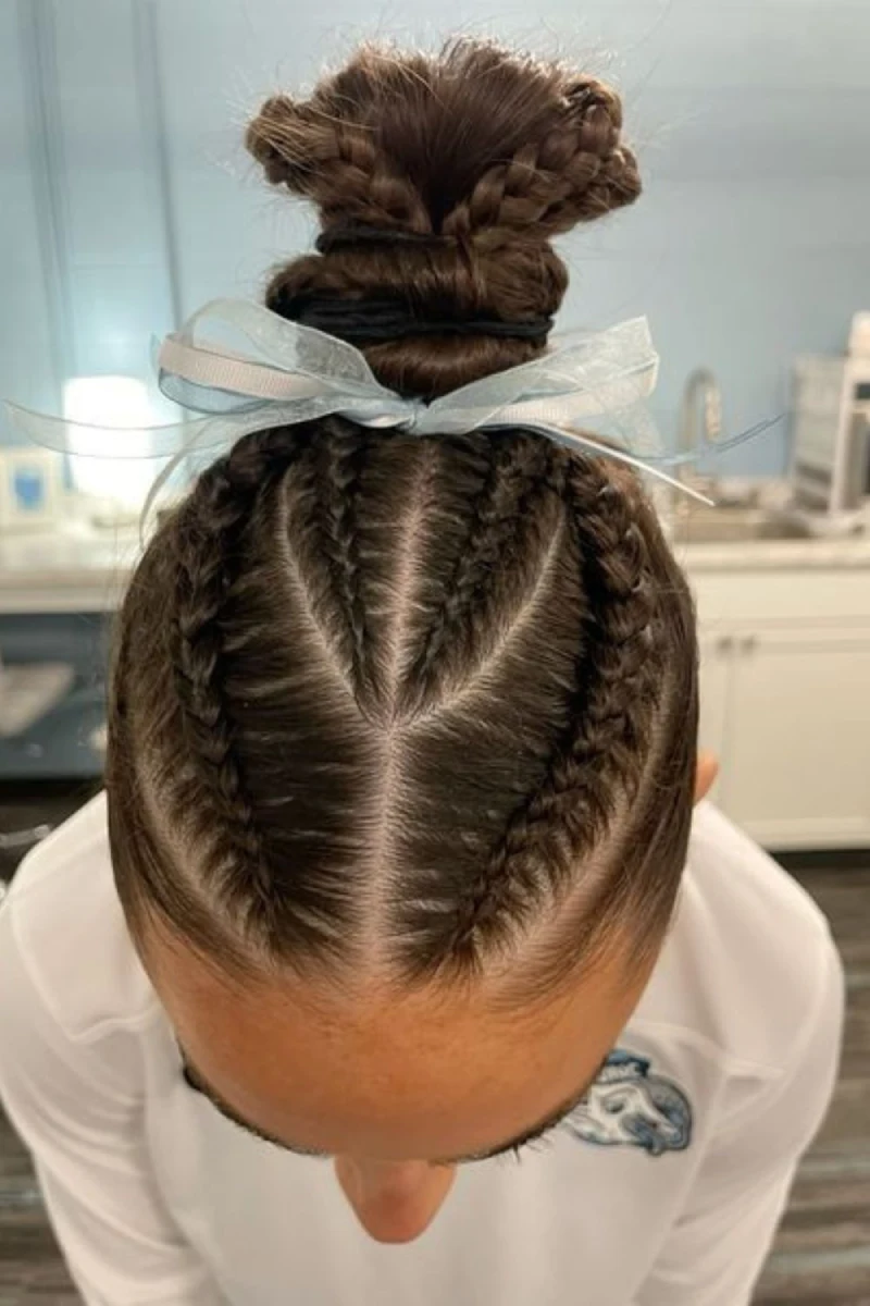 symmetrical cornrow bun style softball hairstyle