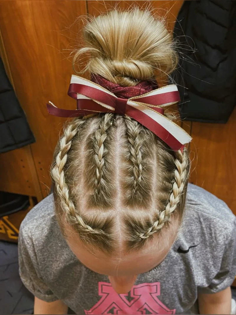 braided top bun with ribbon softball hairstyle