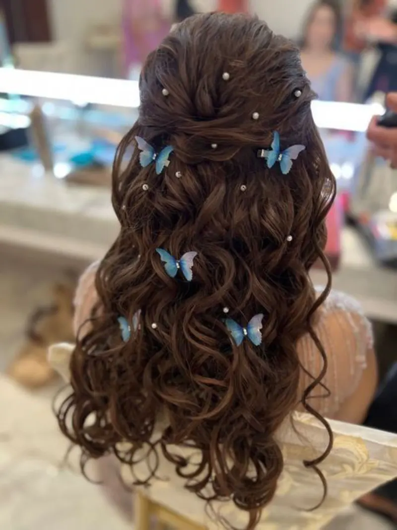 Butterfly-Adorned Half-Up Curls homecoming hairstyle