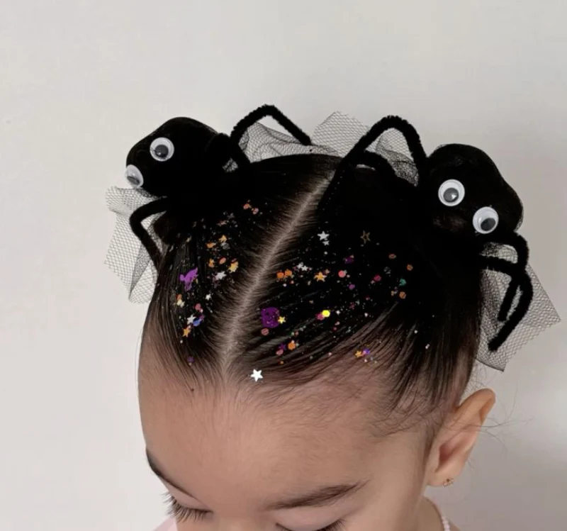 googly-eyed spider buns halloween hairstyle for kids