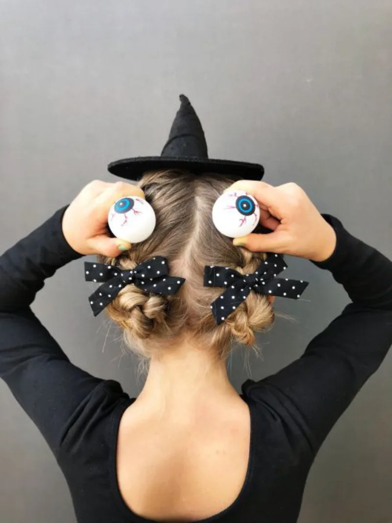 witchy bun with spiders halloween hairstyle for kids
