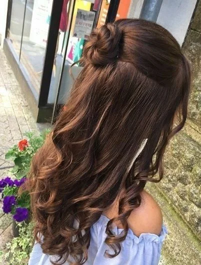 curly half-up bow style winter formal hairstyles